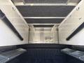 Interior view of a 2019 Ford F-150 truck bed with aluminum construction storage compartments and hooks on the walls for securing cargo