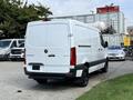 A white 2021 Mercedes-Benz Sprinter van with a black lower trim positioned at the rear