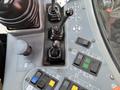 Control panel of a 2018 Sandvik Ranger DX800 featuring various joysticks switches and indicators for operating the equipment