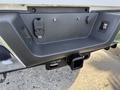 A close-up of the rear bumper of a 2021 Ford F-250 SD showing the hitch receiver and connections for trailer wiring