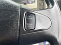 Close-up of a black steering wheel with a control panel featuring buttons for setting and resuming cruise control on a 2013 International DuraStar 4300