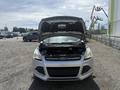 A 2014 Ford Escape with the hood open revealing the engine compartment