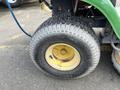 A close-up of a tire from a 2021 John Deere L Series S featuring a yellow rim and textured tread pattern