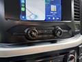 Dashboard controls of a 2021 Ford F-150 featuring climate controls and a touchscreen display with navigation and music options