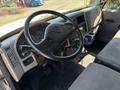 Interior view of a 2011 International 4300 cab showing the steering wheel dashboard controls and seating area