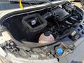 An open engine compartment of a 2019 Mercedes-Benz Sprinter showing various components including a large air intake and a coolant reservoir