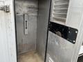 Interior view of a 2012 Workhorse W62 showing a metal panel with a vertical slot grey wall and a metallic surface with grime and wear marks