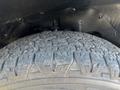 Close-up of a worn tire with distinct tread patterns on a 2020 Chevrolet Express