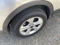 Close-up of a silver 2015 Ford Escape wheel with a distinct tire tread pattern and alloy rim