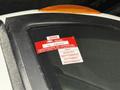 A 2020 International MV607 vehicle with a red certificate of approval sticker attached to the window displaying expiration dates for the months of August to November