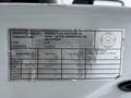 A metal label on a vehicle showing manufacturing details including the manufacturer name, part number, and specifications for weight and tire pressure