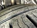 Close-up view of a worn tire tread on a 2014 Honda Odyssey showing visible cracks and reduced depth in the tire grooves