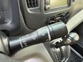 Close-up of a 2021 Nissan NV200 steering column with windshield wiper controls and gear shift lever