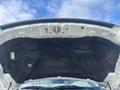 The underside of a 2012 RAM 2500 truck hood showing insulation material and mounting points