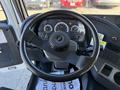 Close-up of the steering wheel and dashboard of a 2012 Autocar XPERT showing gauges and controls