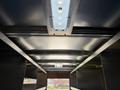 Interior view of a 2016 Ford Transit showing the ceiling structure with mounted lights and metal framing