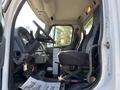 Interior view of a 2006 Freightliner M2 106 truck showing the driver's seat steering wheel and dashboard area
