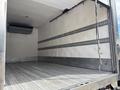 A 2018 Hino 195 truck with an empty cargo area featuring a metal floor and horizontal rail systems along the walls