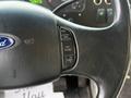 Close-up of the steering wheel controls of a 2018 Ford E-450 showing buttons for cruise control settings