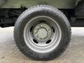 A close-up of a tire mounted on a gray wheel of a 2016 Ford F-550 Super Duty showing the tire tread and wheel design