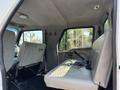Interior view of a 2006 Sterling Acterra showing two rows of gray fabric seats with minimal equipment visible on the floor