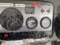 Control panel of a 2010 Kubota RTV 900 featuring hour meter temperature gauge and fuel gauge with visible wear and grime