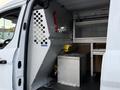 Interior view of a 2017 Ford Transit Connect showing shelving units and storage compartments with metal fittings