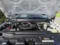 A 2021 Ford F-250 Super Duty with its hood raised revealing the engine compartment and various engine components visible