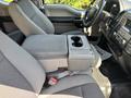 Interior view of a 2019 Ford F-150 showing front seats with a center console and cup holder
