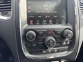 The dashboard of a 2015 Dodge Durango featuring a touchscreen display and various controls for radio climate and audio functions