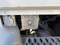 Close-up of a metal switch labeled OFF ON MASTER on a panel with a connector beside it on a vehicle's dashboard