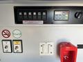 Dashboard controls of a 2013 Chevrolet Express including buttons for lighting volume settings and power outlets