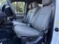 Interior of a 2020 Ford F-350 featuring a front bench seat with cloth upholstery and a simple dashboard design
