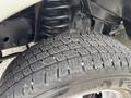 A close-up view of the tread on a tire from a 2014 Ford E-350 showing detailed patterns and grooves designed for traction