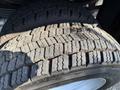 Close-up of a 2008 Ford F-450 SD tire showing detailed tread pattern worn from use