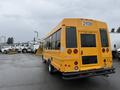 A yellow 2021 Ford Econoline van with a large rear window and number 21139 displayed on the back