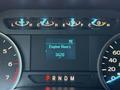 Dashboard display of a 2018 Ford F-150 showing the engine hours and odometer reading with illuminated indicators for temperature and warnings