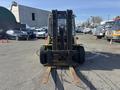 A 1993 Hyster H80XL forklift viewed from the front with a raised fork and large tires positioned in a parking lot
