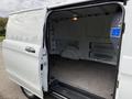 A 2019 Mercedes-Benz Metris van with its sliding side door open revealing an empty, spacious interior and a gray floor surface