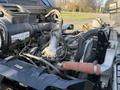 A close-up view of the engine compartment of a 2015 Hino 358 showcasing the various mechanical components including hoses and the intake manifold