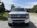 A 2016 Chevrolet Silverado 2500HD is shown from the front featuring a chrome grill and prominent Chevrolet logo with a sleek design and large headlights