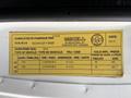 A 2015 GMC Savana with a detailed specifications label showing vehicle information including tire sizes and pressure recommendations