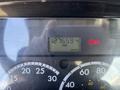 The dashboard of a 2005 Freightliner M2 106 displaying a digital odometer reading 127659.4 KM with warning lights illuminated