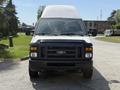 A front view of a 2008 Ford Econoline van with a white roof and black body showcasing its headlights and grille