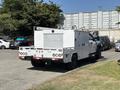A white 2017 Ford F-550 with a utility bed and tool compartments designed for work or service purposes