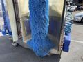 A 2023 Bitimec SC415 vehicle washing machine with blue bristle brushes hanging down, designed for automatic car cleaning