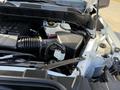 The image shows the engine compartment of a 2024 Chevrolet Silverado 1500 with various components including the air intake and coolant reservoir