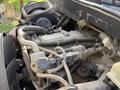 Close-up of a 2010 International 4300 engine showing various components including hoses and wiring connected to the engine block