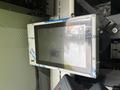A mounted touchscreen display with a protective casing secured to a vehicle interior