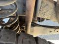 A 2016 Ford F-250 SD showing a close-up of its undercarriage with rusted components including exhaust pipes and suspension springs